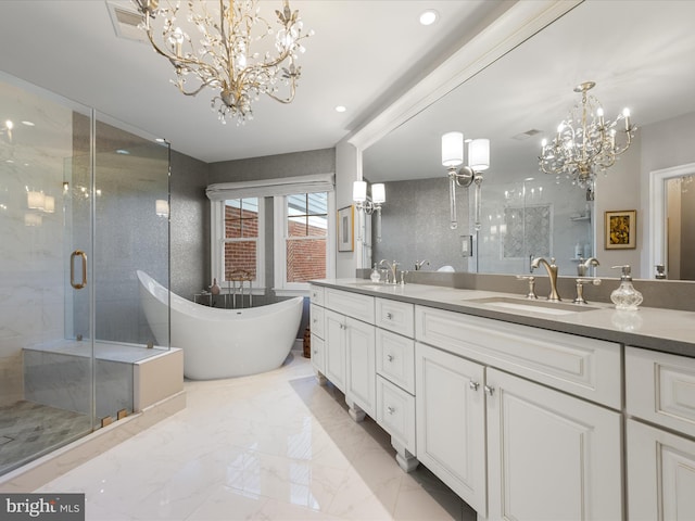 bathroom with a shower stall, double vanity, a soaking tub, marble finish floor, and a sink