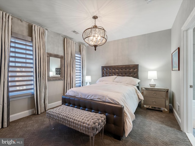 bedroom with multiple windows, baseboards, and visible vents