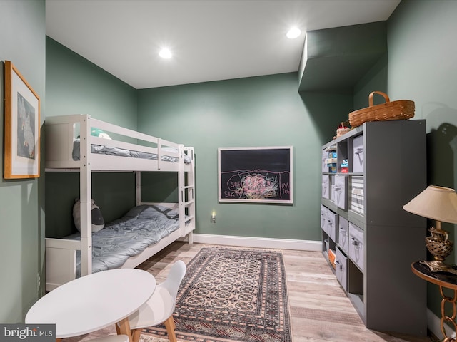 bedroom with recessed lighting, baseboards, and wood finished floors