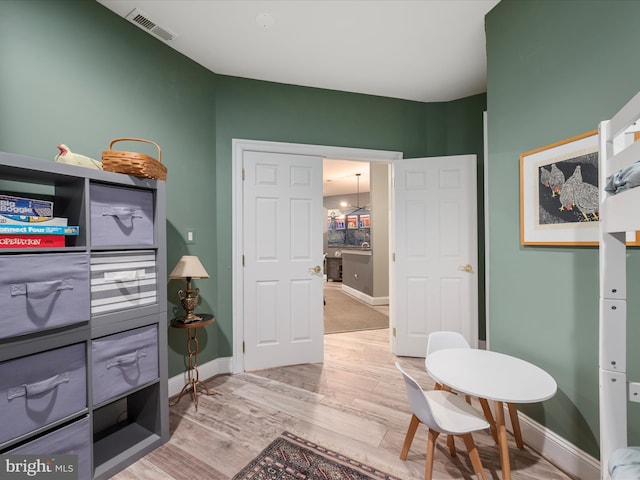 interior space with visible vents, baseboards, and light wood-style floors