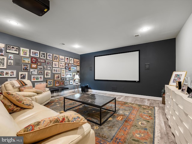 cinema featuring recessed lighting, visible vents, baseboards, and wood finished floors