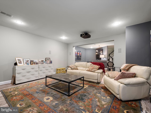 living room with stairway, wood finished floors, visible vents, baseboards, and recessed lighting