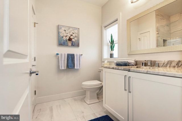 bathroom with vanity, a shower with door, and toilet