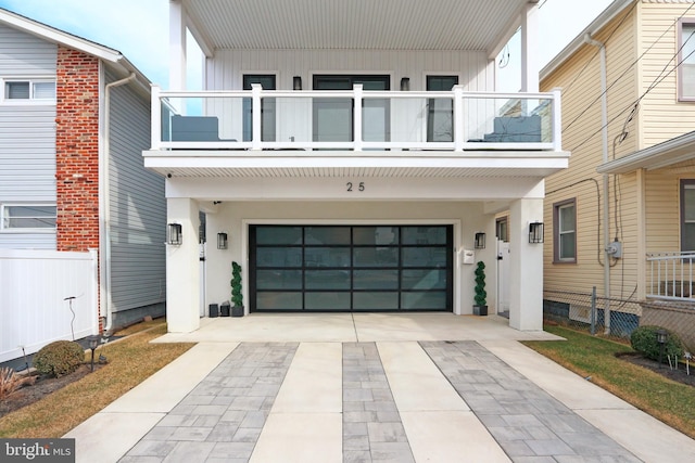 view of front of house with a garage and a balcony