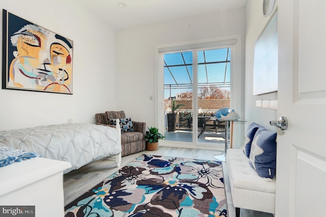 bedroom featuring access to exterior and wood-type flooring