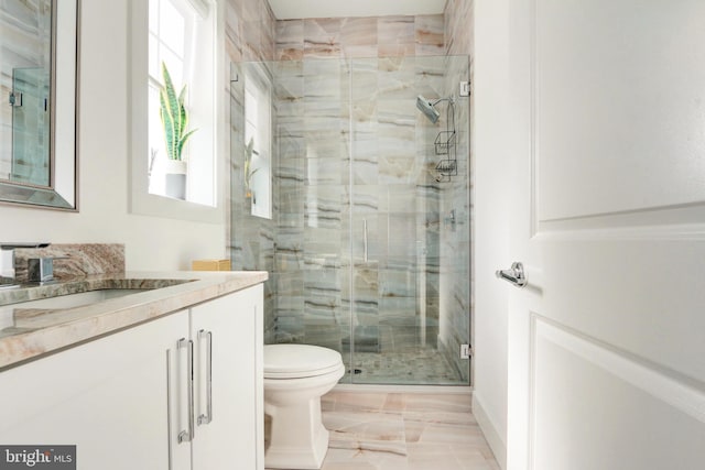 bathroom with vanity, toilet, and an enclosed shower