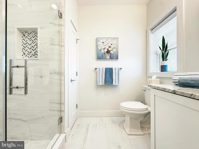 bathroom featuring vanity, toilet, and walk in shower