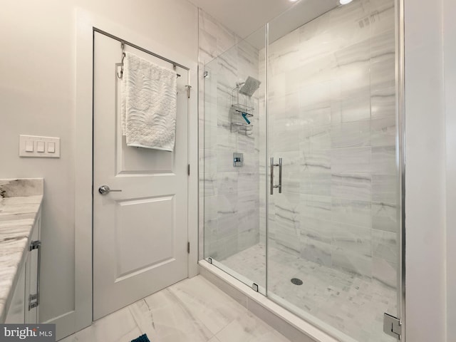 bathroom with walk in shower and vanity