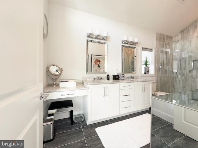 bathroom featuring vaulted ceiling, vanity, tile patterned flooring, and a tile shower