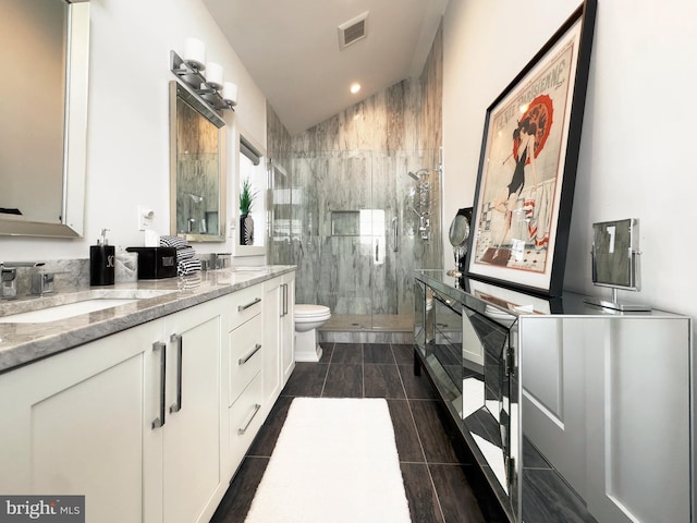 bathroom with walk in shower, lofted ceiling, vanity, and toilet