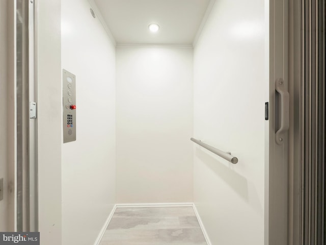 interior space featuring elevator and light wood-type flooring