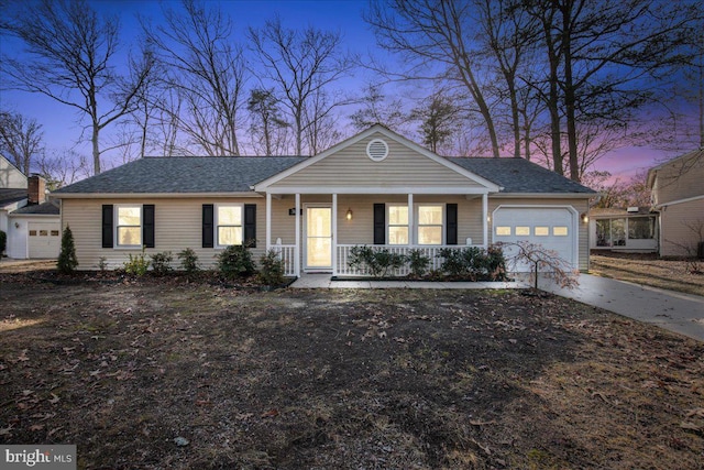 ranch-style home with a garage and covered porch