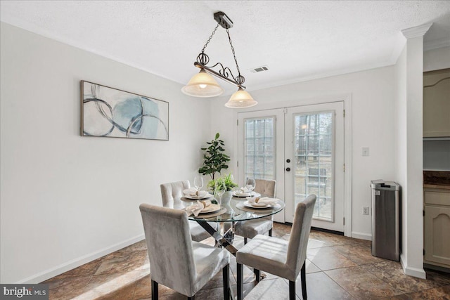 dining room featuring french doors, crown molding, and a textured ceiling