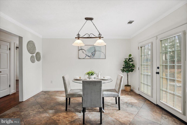 dining room featuring ornamental molding, french doors, and a textured ceiling