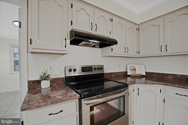 kitchen with white cabinetry, ornamental molding, light tile patterned floors, and electric range