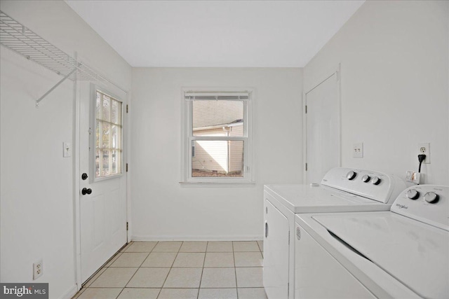 laundry room with light tile patterned floors and washing machine and clothes dryer