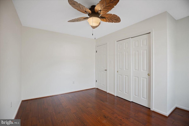 unfurnished bedroom with ceiling fan and dark hardwood / wood-style flooring