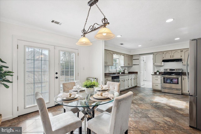 dining room featuring ornamental molding and french doors