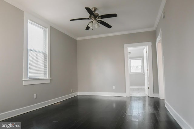 spare room with dark wood-type flooring, ceiling fan, and ornamental molding