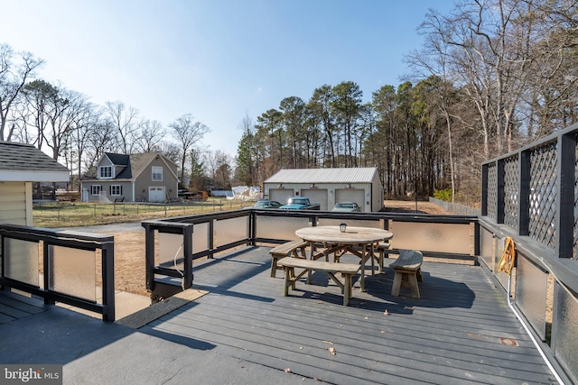 deck featuring an outbuilding and a garage