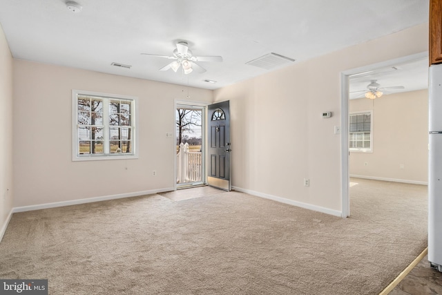 empty room with light colored carpet and ceiling fan