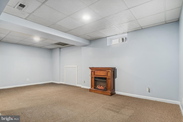 basement with carpet and a drop ceiling