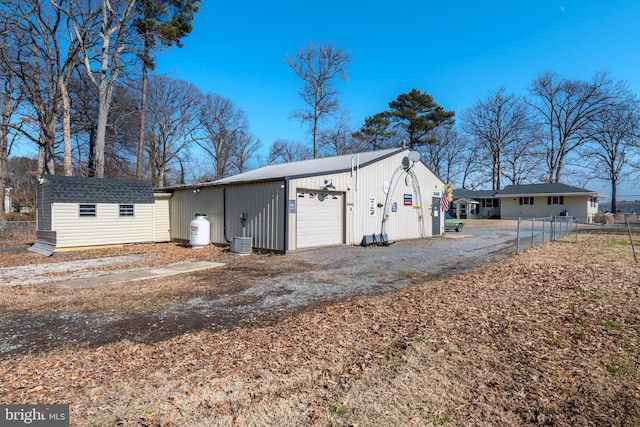 view of outdoor structure featuring a garage and central AC