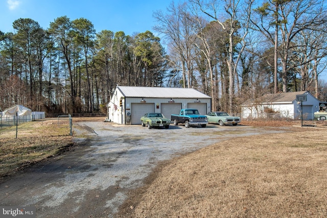 exterior space with a garage and a lawn