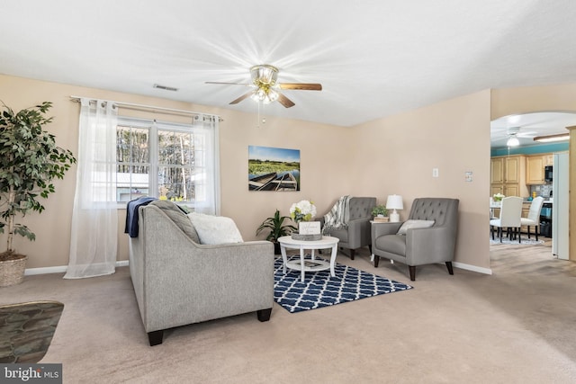 carpeted living room featuring ceiling fan