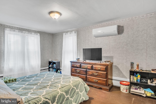 bedroom with a baseboard heating unit and a wall mounted AC