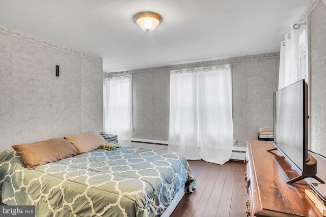 bedroom featuring dark wood-type flooring and baseboard heating