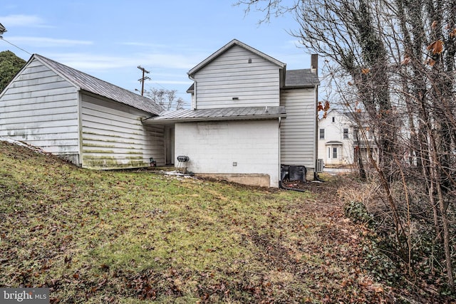 rear view of property with a lawn