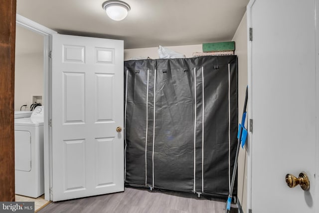 bathroom with washer / clothes dryer and hardwood / wood-style floors