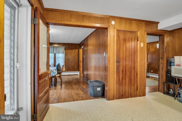 hall with wooden walls and baseboard heating