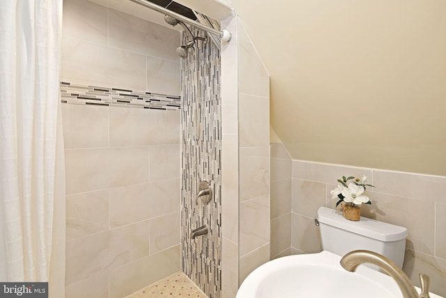 1034 Excelsior Dr, Upper Chichester, PA 19014 - bathroom with walk in shower, toilet, sink, vaulted ceiling, and tile walls