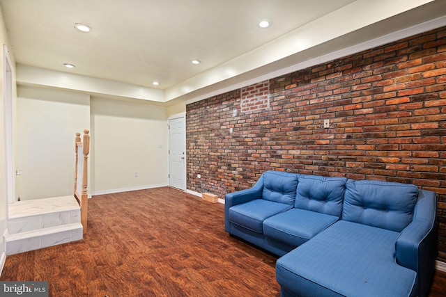 1034 Excelsior Dr, Upper Chichester, PA 19014 - unfurnished living room featuring brick wall and dark hardwood / wood-style flooring