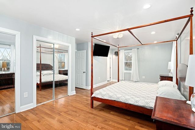 1034 Excelsior Dr, Upper Chichester, PA 19014 - bedroom featuring multiple windows, two closets, and light wood-type flooring