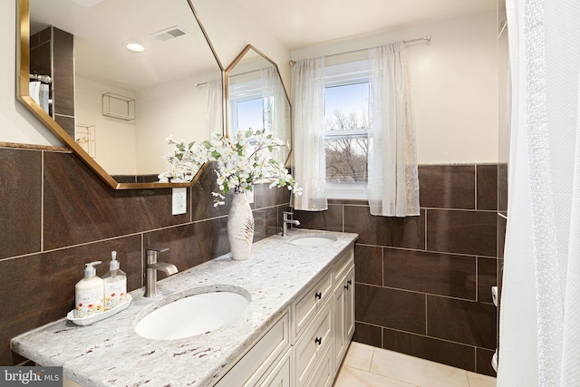 1034 Excelsior Dr, Upper Chichester, PA 19014 - bathroom featuring vanity, tile walls, and tile patterned floors