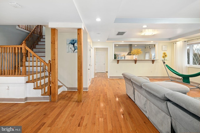 1034 Excelsior Dr, Upper Chichester, PA 19014 - living room featuring light wood-type flooring and a tray ceiling