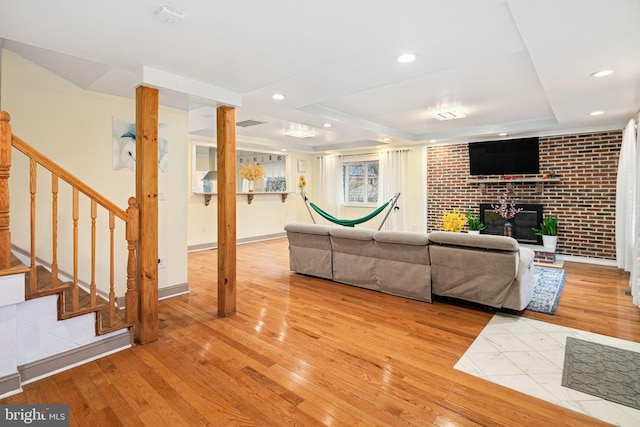 1034 Excelsior Dr, Upper Chichester, PA 19014 - unfurnished living room with a fireplace, light hardwood / wood-style floors, and a tray ceiling