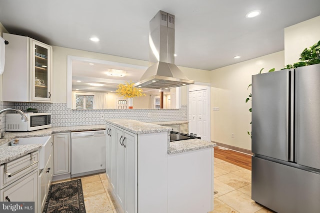 1034 Excelsior Dr, Upper Chichester, PA 19014 - kitchen with light stone counters, white appliances, island range hood, and a center island