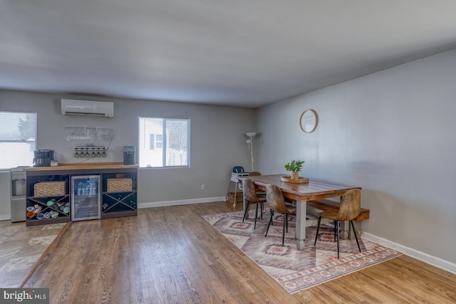 dining room featuring hardwood / wood-style floors, a wall mounted AC, and beverage cooler