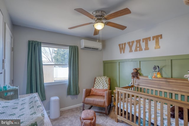 carpeted bedroom with a wall mounted air conditioner, a crib, and ceiling fan