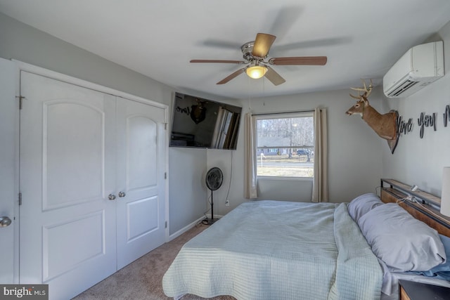 bedroom featuring light carpet, a wall mounted AC, ceiling fan, and a closet