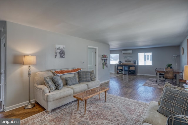 living room with hardwood / wood-style floors and a wall unit AC