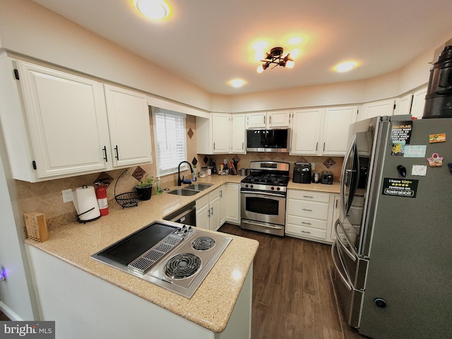 kitchen with sink, backsplash, stainless steel appliances, dark wood-type flooring, and white cabinets