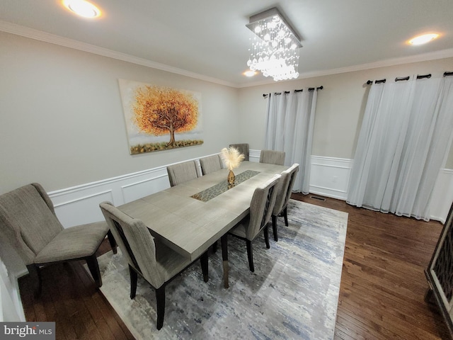 dining space featuring ornamental molding, an inviting chandelier, and dark hardwood / wood-style flooring