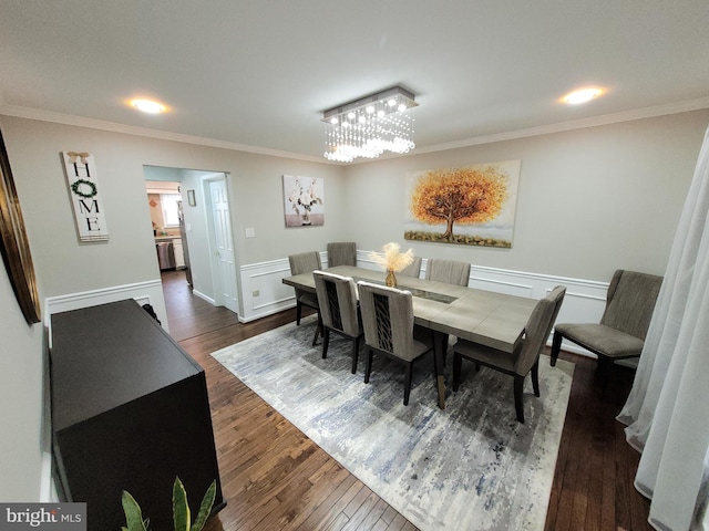 dining area with dark wood-type flooring and ornamental molding