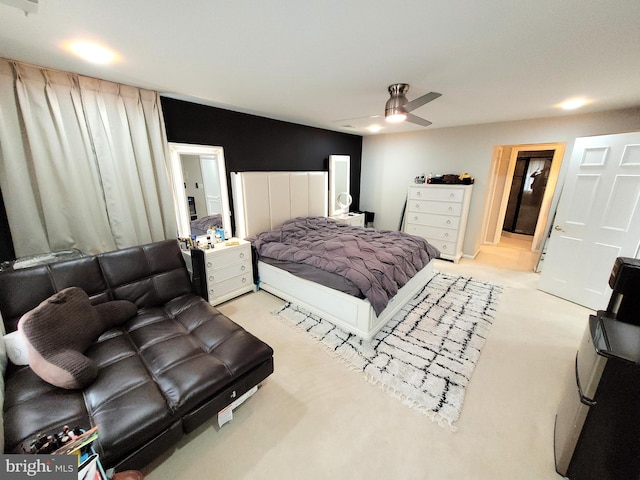 bedroom featuring light carpet and ceiling fan