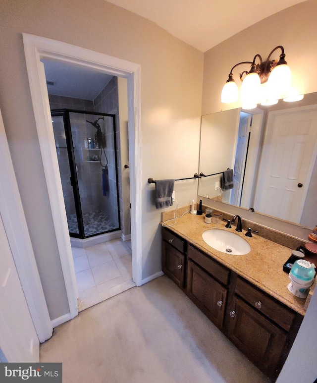 bathroom with vanity and a shower with door